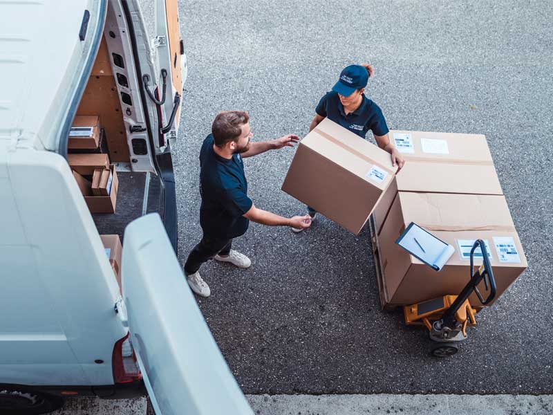 loading the van with cardboard boxes